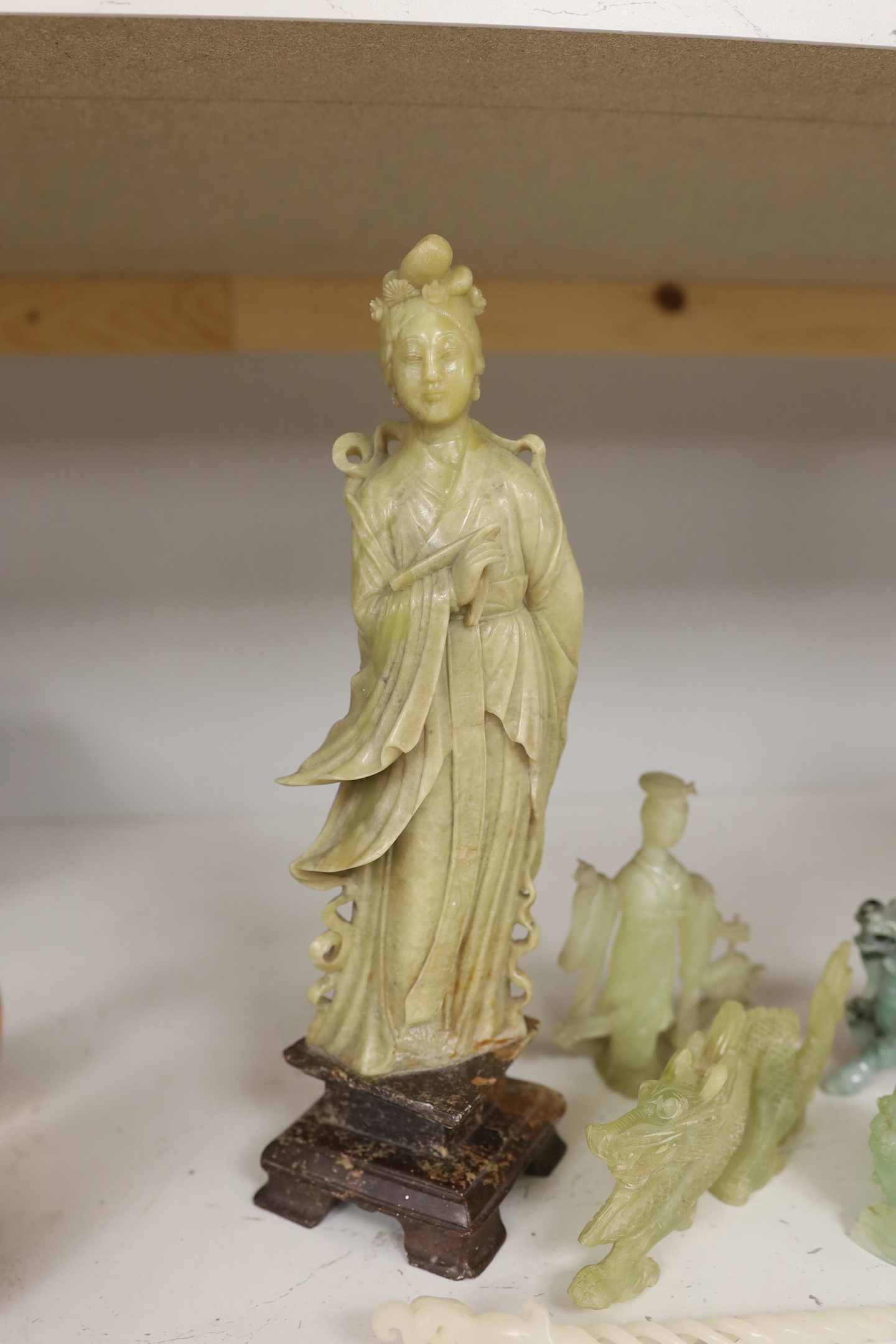 A Chinese soapstone figure, a jadeite figure of a qilin and various bowenite figures etc., tallest 30cm